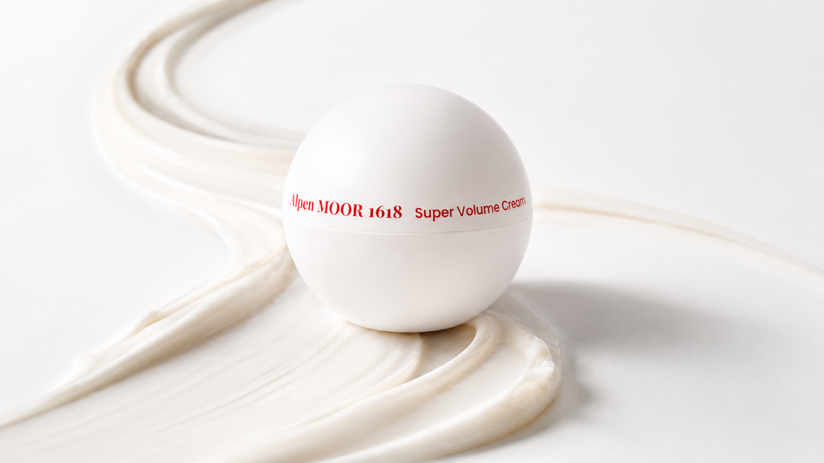 Super Volume Cream jar resting on a curved cream ribbon showing how the rich formula spreads