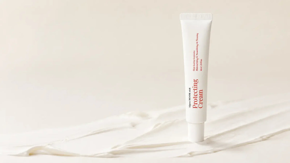 Alpen MOOR 1618 Protecting Cream tube standing upright on soft swipes of white cream