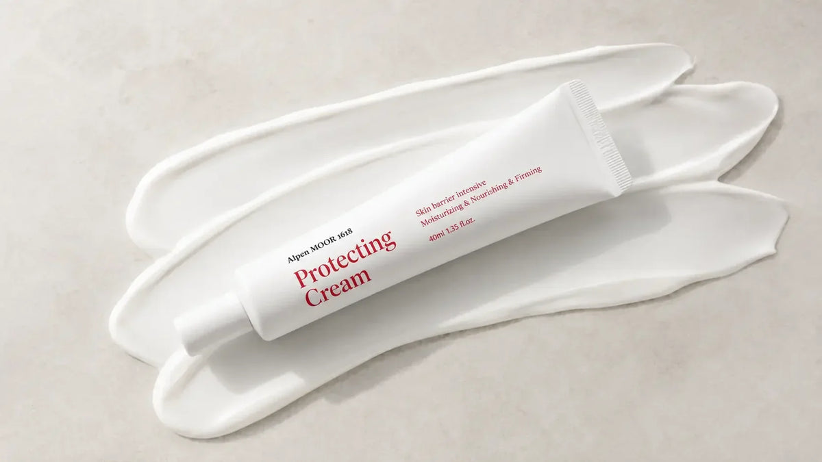 Alpen MOOR 1618 Protecting Cream tube lying on broad swipes of white cream